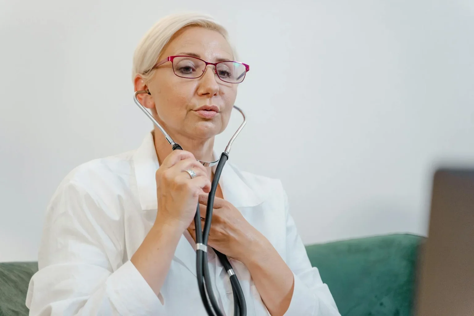Female doctor consulting with elderly patient about knee health