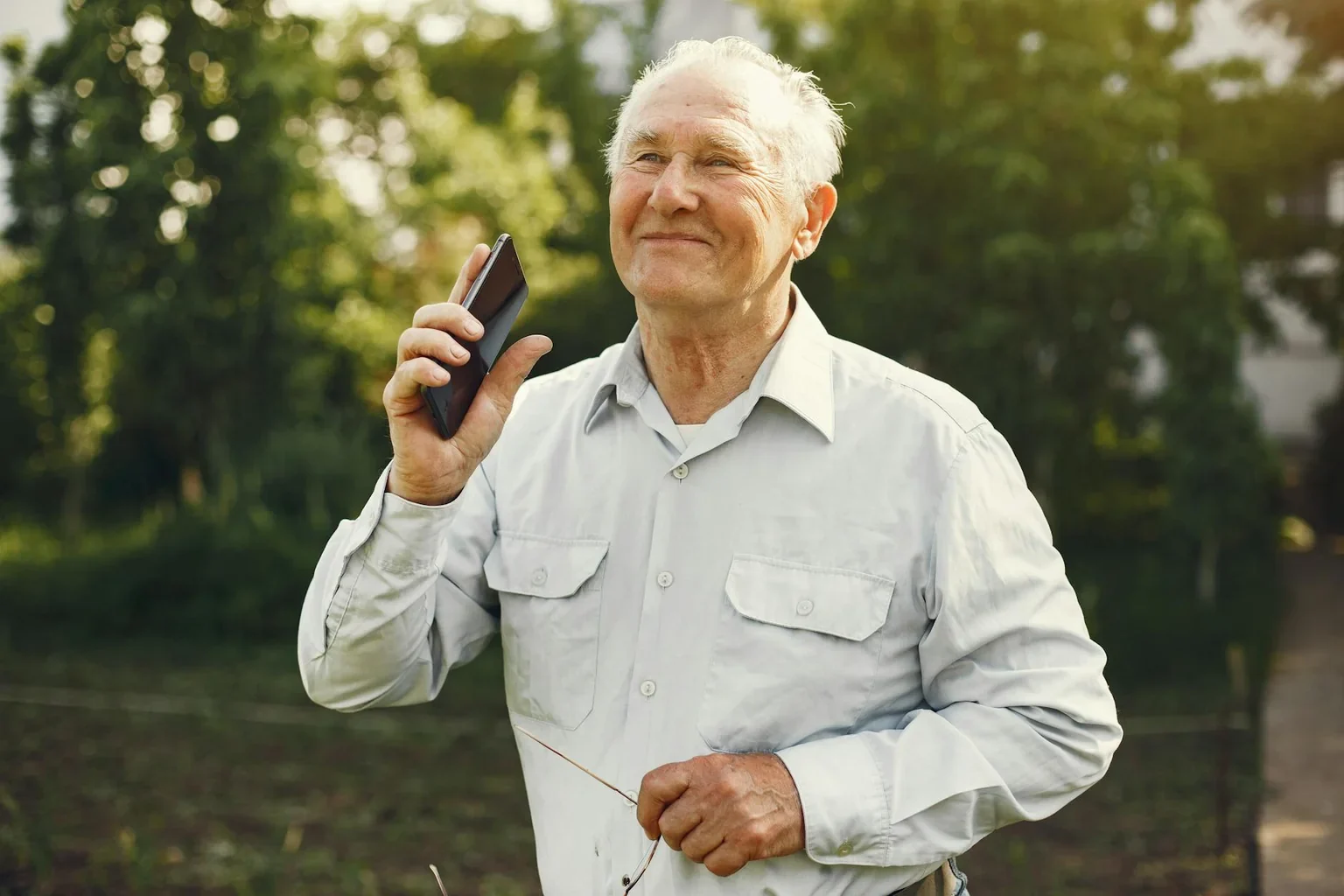 Smiling elderly man enjoying outdoor activity after knee replacement recovery