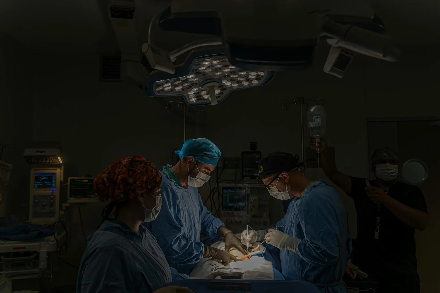 A surgical team conducts an operation in a well-equipped hospital operating room in Mexico.
